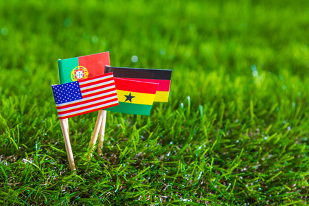 Paper cut of flags on grass for Soccer championship 2014 , group Gの写真素材