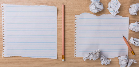 White note book paper with  pencil and crumpled on a wooden deskの写真素材