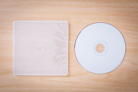 Blank compact disc with cover on wood background groundの写真素材