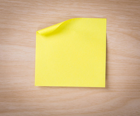 Close up of note paper on wooden background