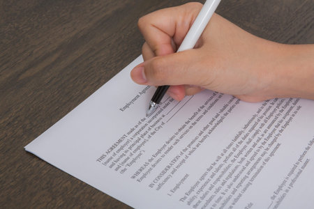 Close up of hand completing an employment application form