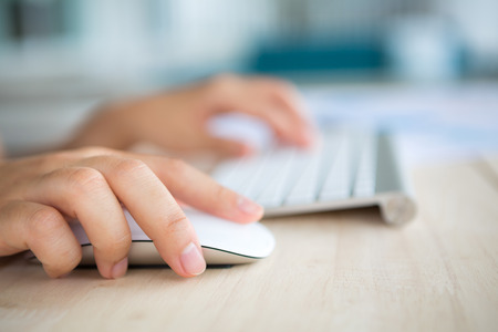 Closeup of business woman hand typing on keyboard and mouse Closeup of business woman hand typing on keyboard and mouse