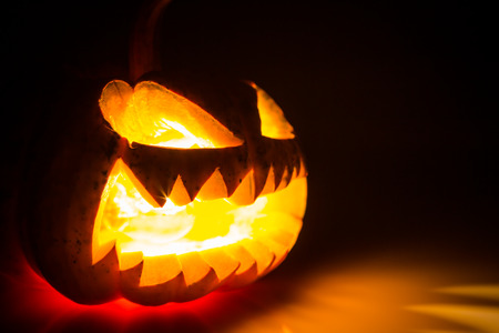 Halloween scary face pumpkin on black backgroundの写真素材