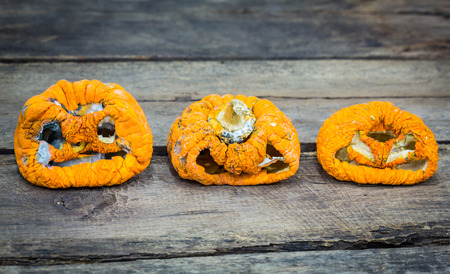 Old halloween pumpkin on woodの写真素材