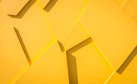 Abstract yellow triangles wall backgroundの写真素材