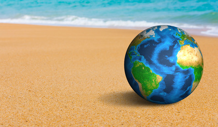 Earth globe on the sea beachの写真素材