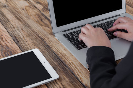 Closeup of business woman hand typing on laptop keyboard
