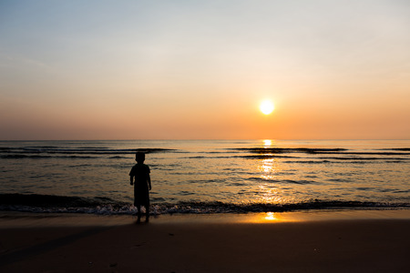 Silhouette of child on the beachの写真素材