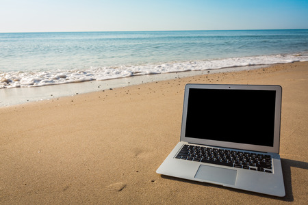 Laptop on the beach in summer timeの写真素材
