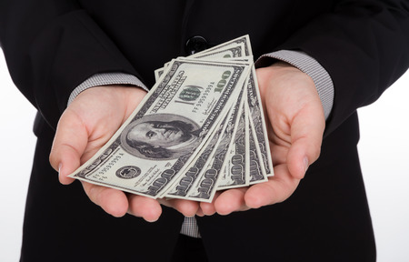 Business man Displaying a Spread of Dollarの写真素材