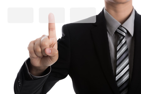 Business man touching an imaginary screen against white backgroundの写真素材