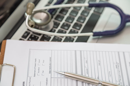 Stethoscope and prescription on laptop