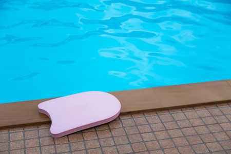 Pink boogie board in swimming poolの写真素材