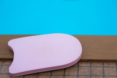 Pink boogie board in swimming poolの写真素材