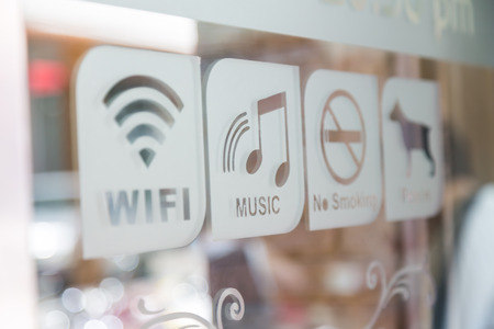Signs on glass door (Free Wifi, Music, No smoke, Pet in)の写真素材