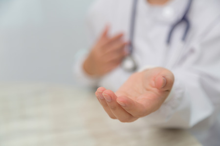 Doctor holding something in his handの写真素材