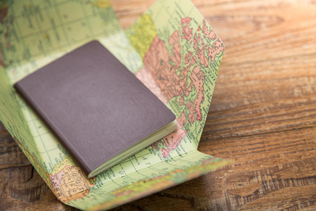 Blank passport with Map on wood tableの写真素材