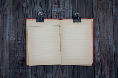Black clip and book hang on wood backgroundの写真素材