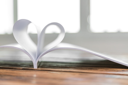 Book with opened pages of shape of heartの写真素材