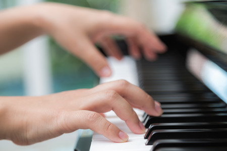 Close up of woman hands  playing pianoの写真素材