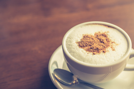 Hot latte art coffee on table ( Filtered image processed vintage effect. )の写真素材