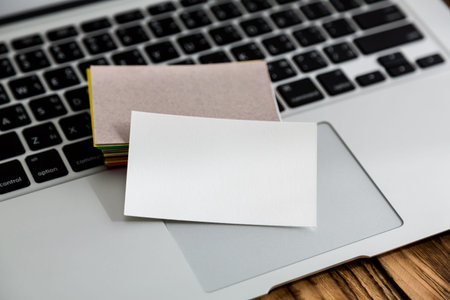 Business card on laptop keyboardの写真素材