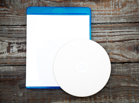 Blank compact disc with cover on wood background groundの写真素材