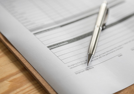 Close up of pen on formal paperの写真素材