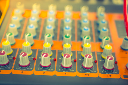 Music mixer desk with various knobs ( Filtered image processed vintage effect. )