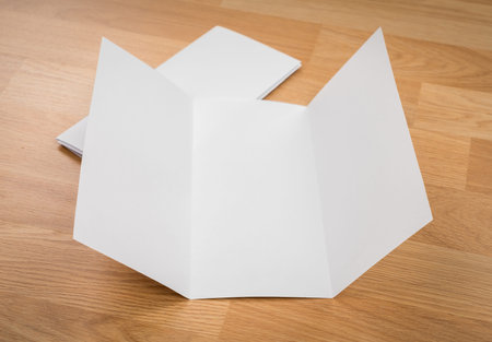 Trifold white template paper on wood texture