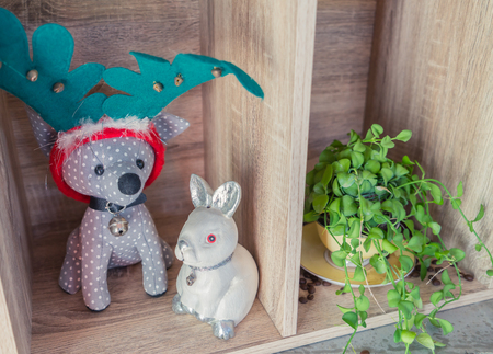 Dog as deer doll with rabitの写真素材