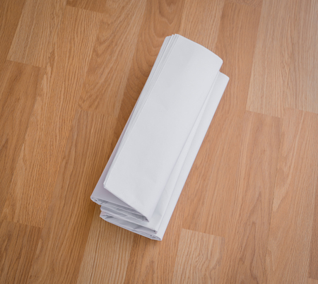 Blank Newspaper with empty space mock up on wood backgroundの写真素材