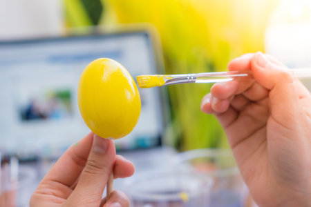 Woman hand  decorating Easter eggs