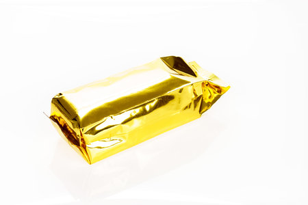 Golden foil bag package on white backgroundの写真素材