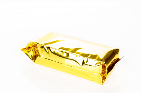 Golden foil bag package on white backgroundの写真素材
