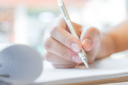 Hand with pen over application formの写真素材