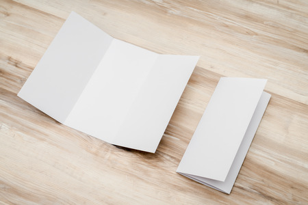 Trifold white template paper on wood textureの写真素材