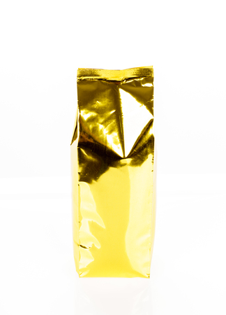 Golden foil bag package on white backgroundの写真素材