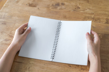 Hands open Blank catalog, magazines,book mock up on wood table
