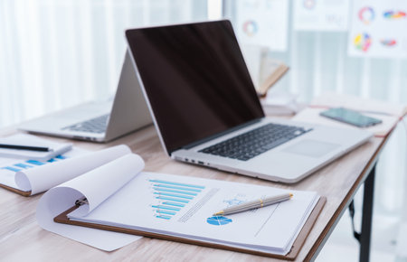 Financial charts on the table with laptop