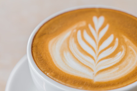 Latte Coffee art on the tableの写真素材