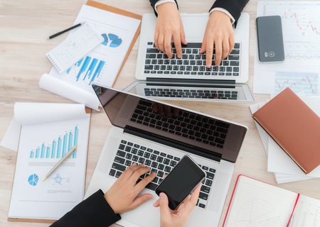 Business people using laptop  and Financial charts  at meeting office