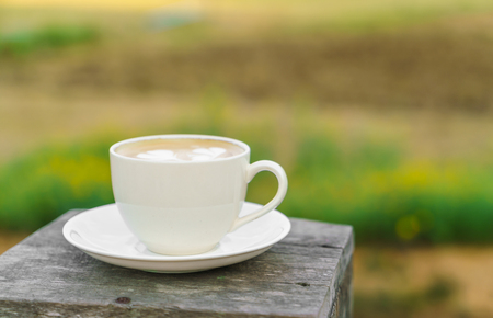 Latte Coffee art on the wooden tableの写真素材