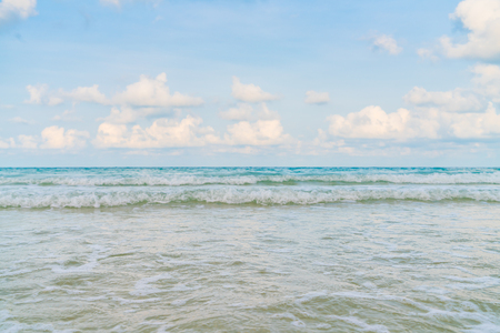 Beautiful white sand beach with blue sea and skyの写真素材