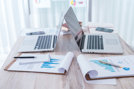 Financial charts on the table with laptopの写真素材