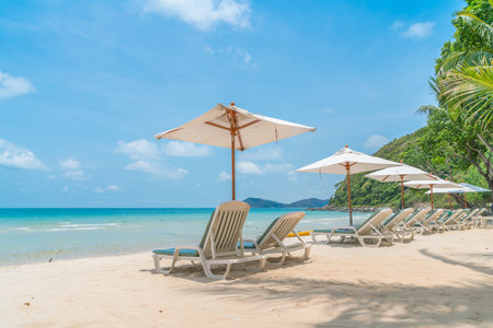 Beautiful beach chairs with umbrella on tropical white sand beachの写真素材