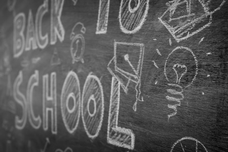 Freehand drawing Back to school on chalkboard ,Filtered image processed black and white effect.の写真素材