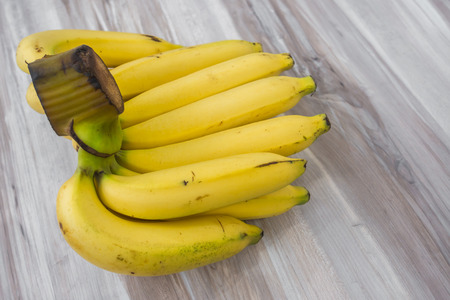 Fresh bananas on wooden tableの写真素材