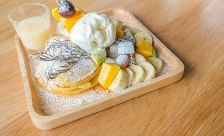 Pancake and fruit with ice cream on tableの写真素材