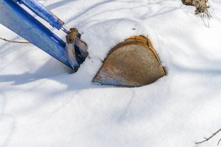 Tractor with snow plow in winter